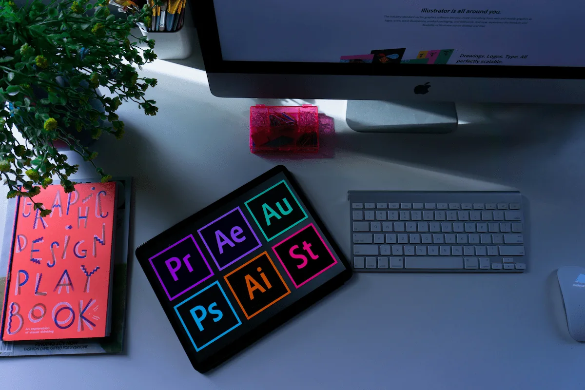a graphic designer computer,sketch book,tools